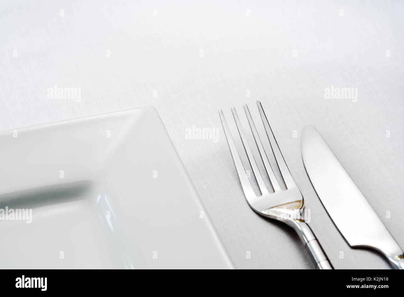 Single place table setting, knife fork plate. Stock Photo