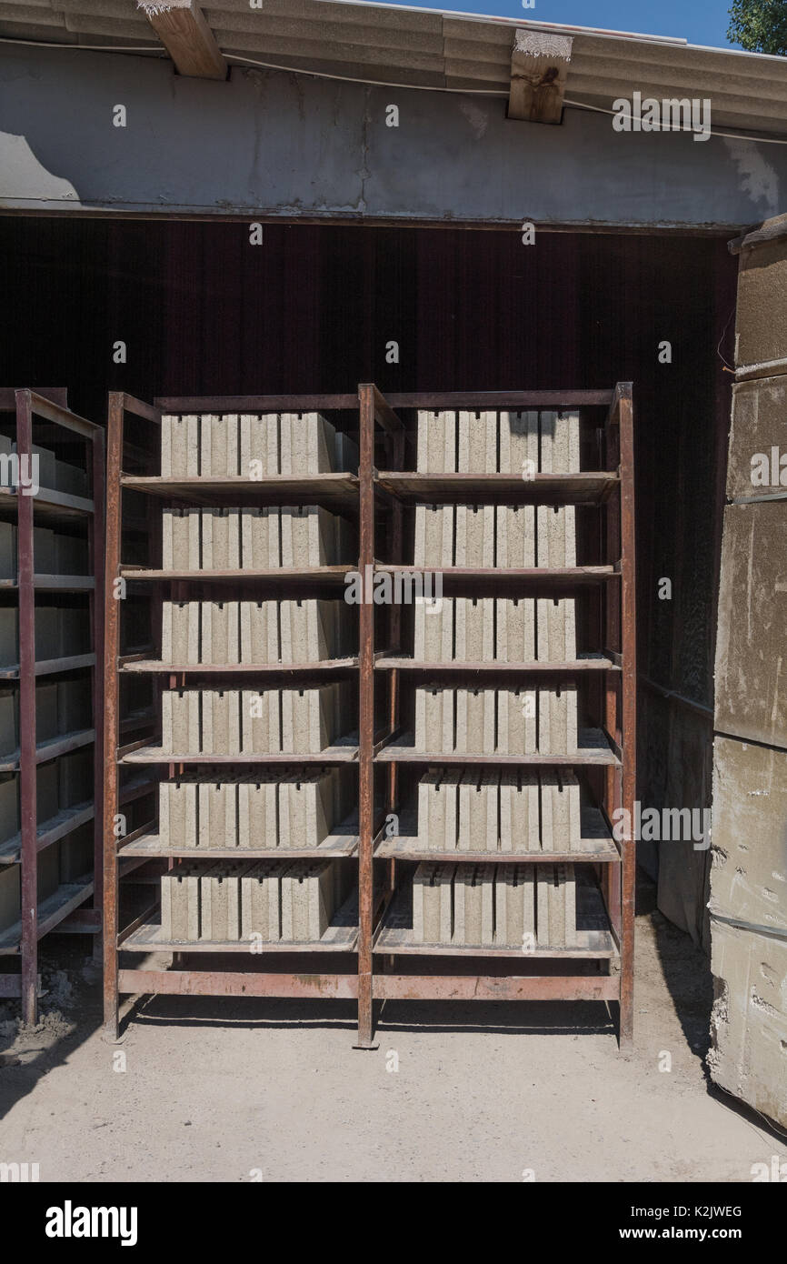 Cement blocks on the shelves of a metal tray in the dryer. Drier cement