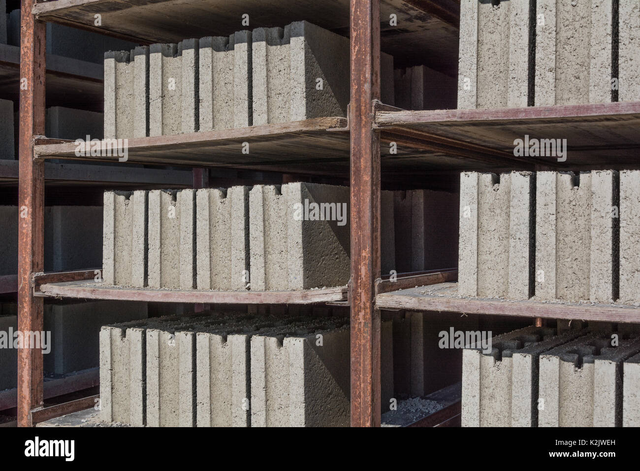 Cement blocks on the shelves of a metal tray in the dryer. Drier cement