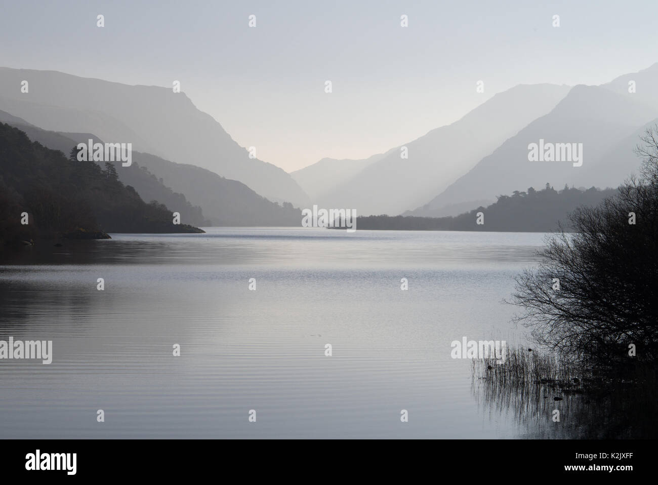 Llyn Padarn is a large  glacially formed lake in Snowdonia here seen looking towards mount Snowdon and the Llanberis Pass. Stock Photo