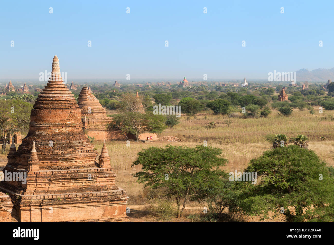 Many old pagodas and other buildings at the ancient plain of Bagan in Myanmar (Burma), viewed from the Bulethi (Buledi) Temple on a sunny day. Stock Photo