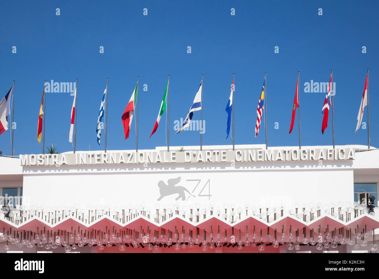 Lido, Venice, Italy. 30th Aug, 2017. Venues for the 2017 Film Festival after last minute preparations and installations and before the crowds arrive for the opening of the festival. The signage and country flags on the facade of the Mostra Internazionale d'Arte Cinematografica. Stock Photo