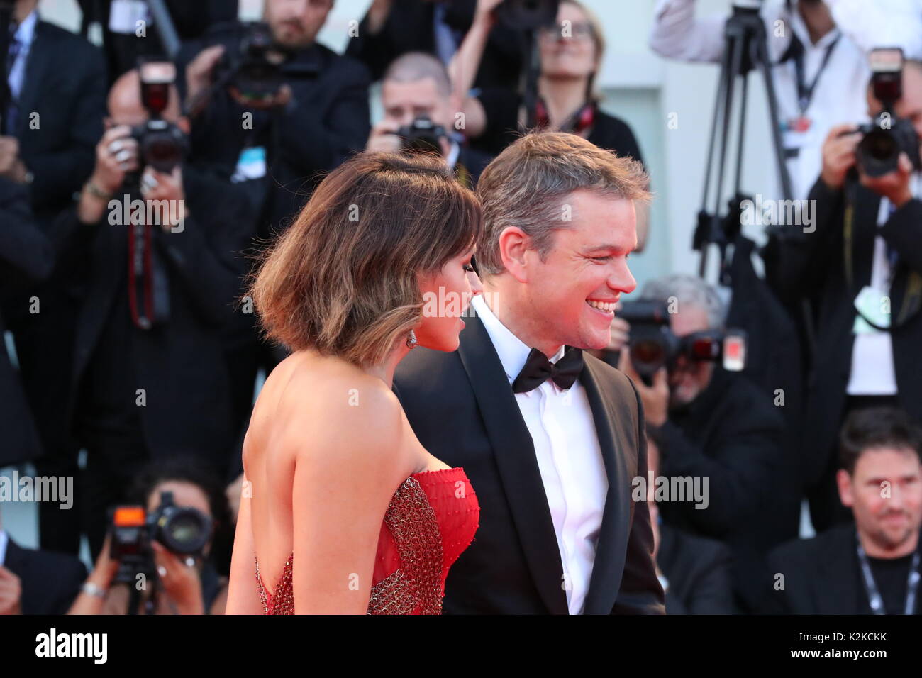 Venice, Italy. 30th Aug, 2017. VENICE, ITALY - AUGUST 30: Luciana Barroso and Matt Damon walk the red carpet ahead of the 'Downsizing' screening and Opening Ceremony during the 74th Venice Film Festival at Sala Grande on August 30, 2017 in Venice, Italy. Credit: Graziano Quaglia/Alamy Live News Stock Photo