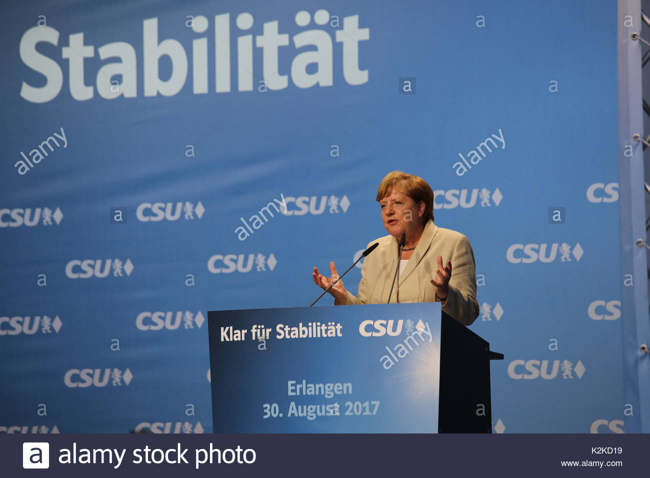 An expressive gesture as Angela Merkel calmly speaks to a large crowd on the campaign trail in the run up to the German election which is taking place on Sunday, September 24.Merkel spoke for over forty minutes and was well received though a small group of protestors tried to interrupt her speech with whistles and catcalls. She and her sister party the Bavarian CSU currently enjoy good ratings in the polls over the SPD and many expect to be returned to office for a fourth term. Stock Photo