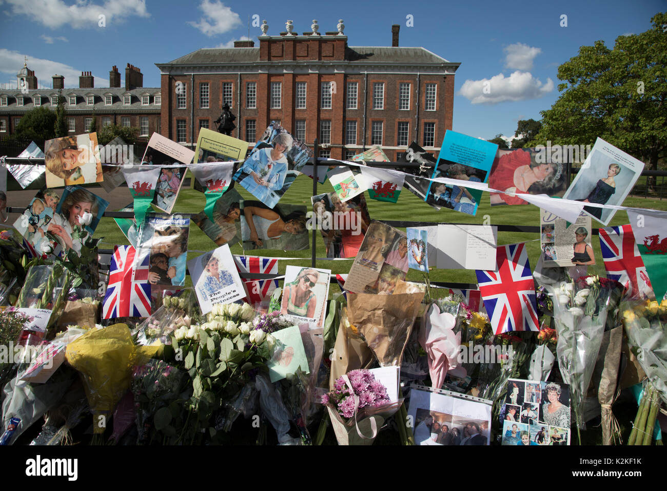 On the 20th anniversary of the death of Princess Diana, crowds of people gather to pay their respects, and to lay flowers, pictures and messages at the memorial to her on 31st August 2017 at Kensington Palace in London, United Kingdom. Diana, Princess of Wales became known as the People's Princess following her tragic death, and now as in 1997, thousands of royalists, and mourners came to her royal residence in remembrance. Stock Photo