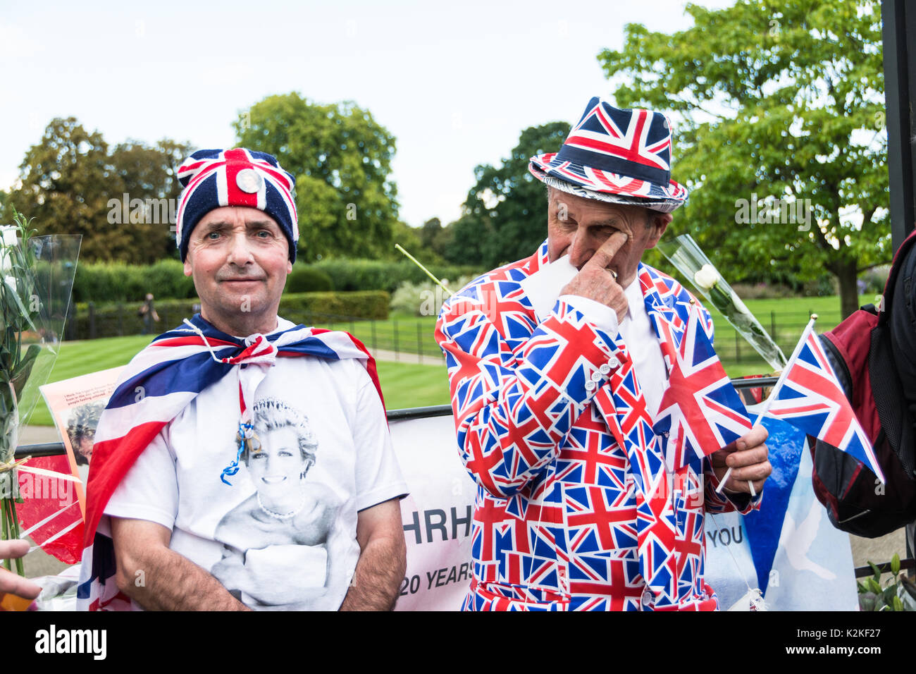 Royal fans John Loughrey and Terry Hutt outside the gates of Kensington Palace to commemorate and pay tribute to Princess Diana, twenty years after her death. Stock Photo