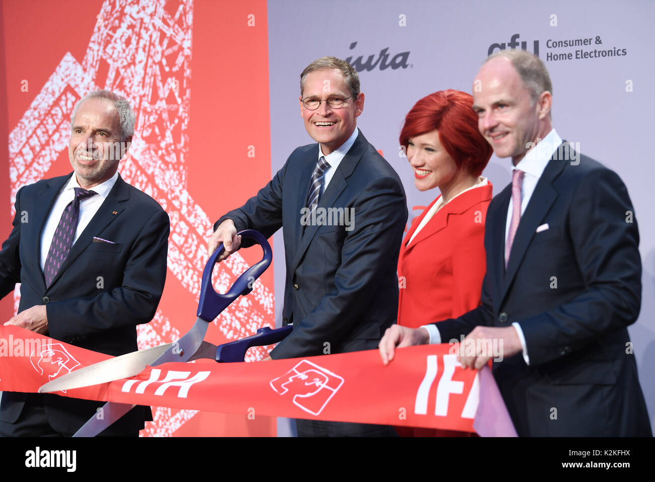 Berlin, Germany. 31st Aug, 2017. Hans-Joachim Kamp (L-R), chief of the supervisory board of the gfu Consumer & Home Electronics GmbH, Berlin's mayor Michael Mueller (SPD), Miss IFA and Christian Goeke, chairman of the board of the Berlin fair open the the IFA 2017 industrial exhibition at the opening gala in Berlin, Germany, 31 August 2017. Photo: Jens Kalaene/dpa-Zentralbild/dpa/Alamy Live News Stock Photo