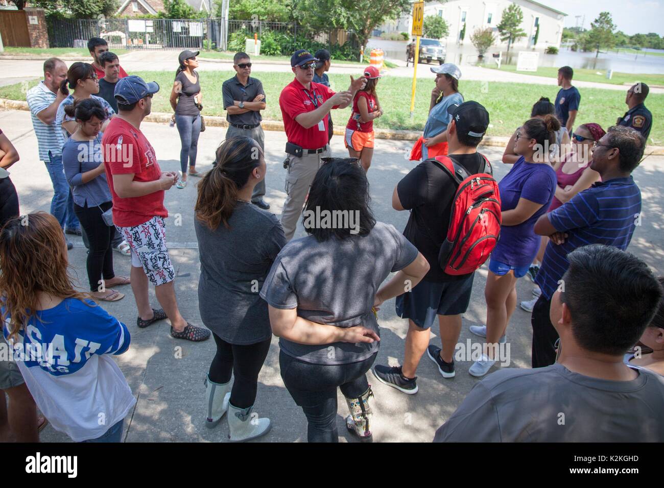 Houston, USA. August 31, 2017: Harris County ESD 48 Public Information Officer Lieutenant Simon VanDyk (center) briefs flood victims who were evacuated from their homes due to flooding caused by Hurricane Harvey in Houston, TX. John Glaser/CSM./Alamy Live News Stock Photo