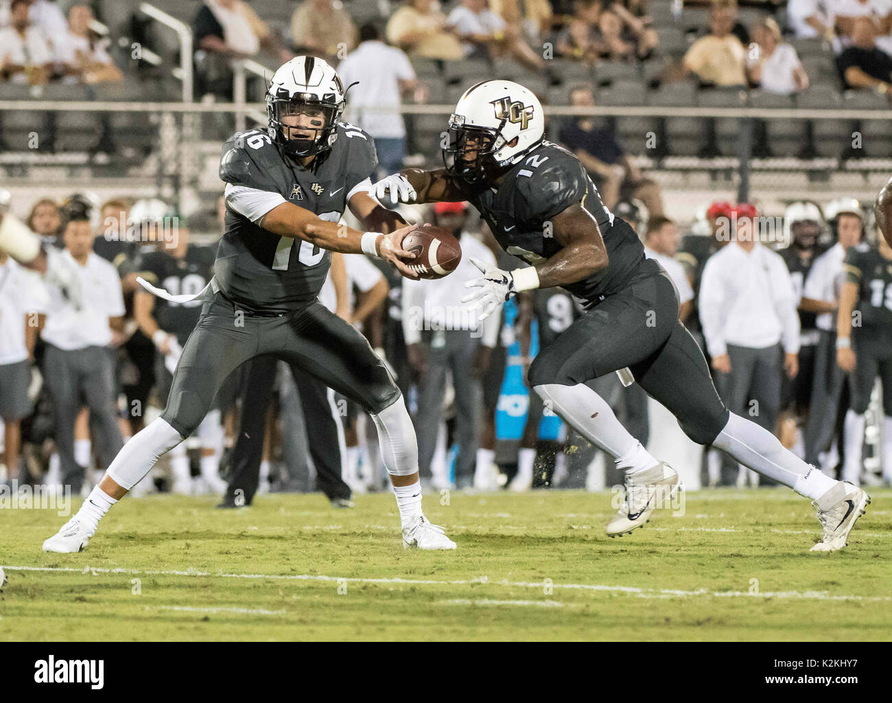 August 31, 2017 - Orlando, FL, U.S: UCF Knights quarterback Noah Vedral (16) hands the ball off to UCF Knights running back Taj McGowan (12) during NCAA football game between FIU Golden Panthers and the UCF Knights at Spectrum Stadium in Orlando, Fl. Romeo T Guzman/CSM. Stock Photo