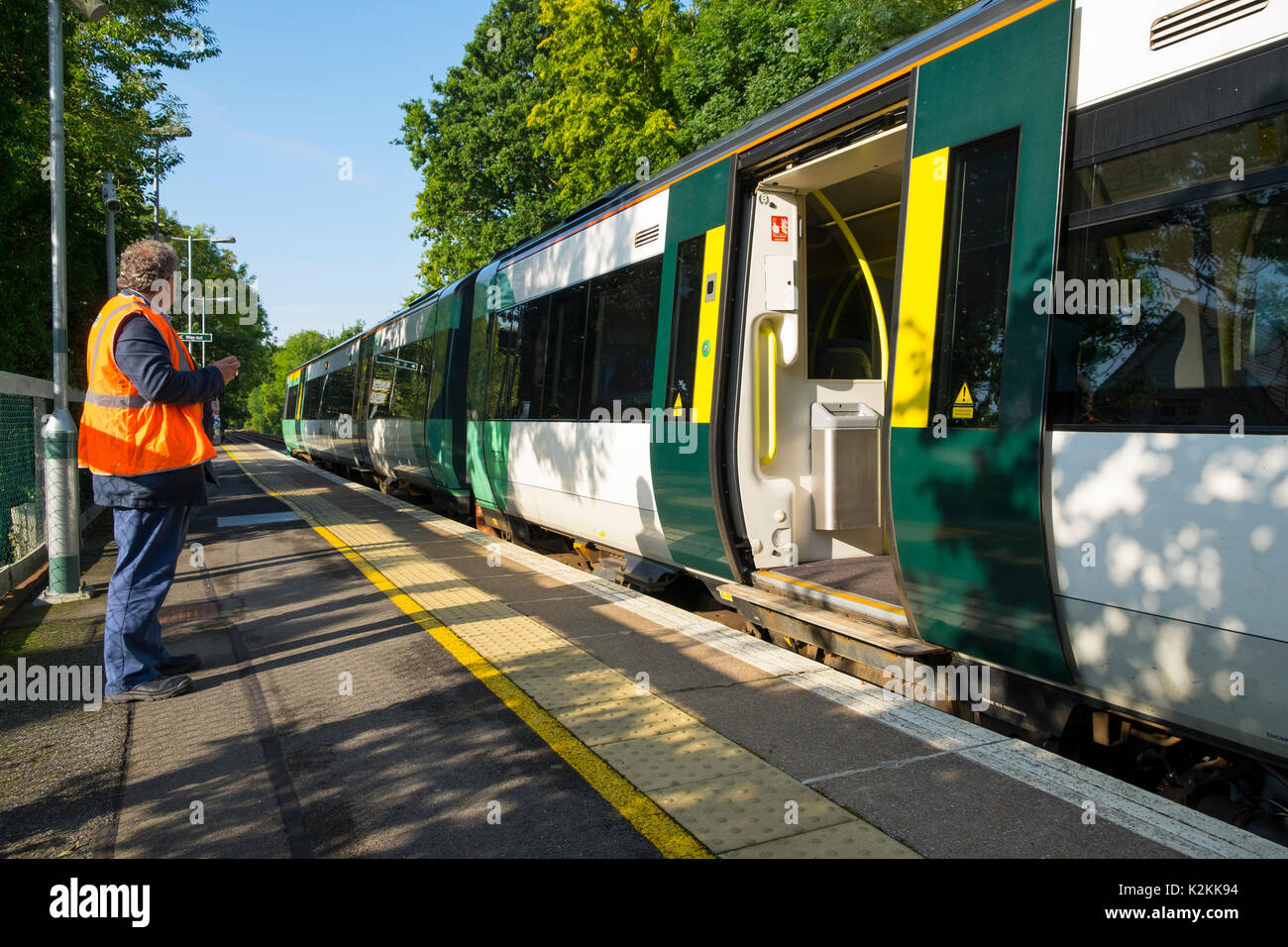 Southern Railways door guard in uniform on a train standing on Stock