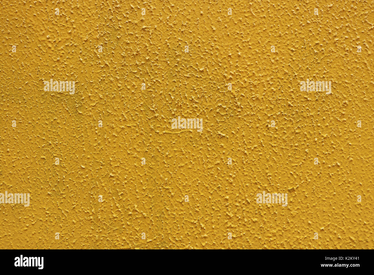 Yellow rough paint concrete wall surface. Painted cement structure
