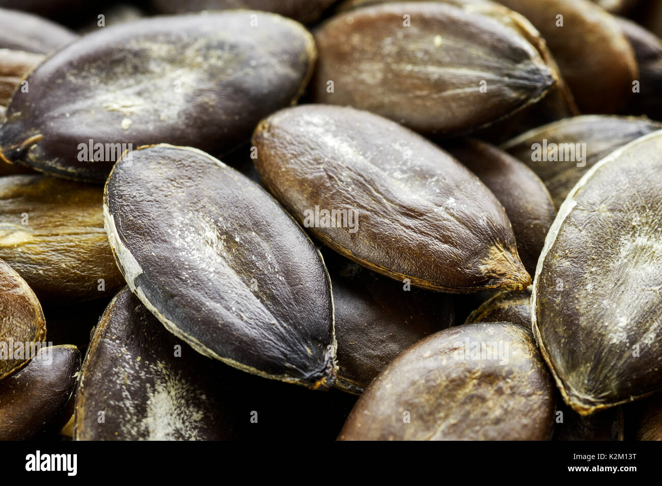 Extreme close up picture of pumpkin seeds, shallow depth of field. Stock Photo