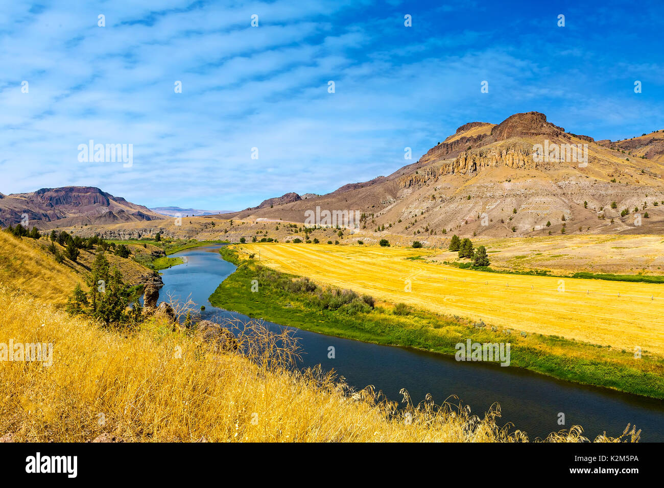 John Day River in Central Oregon on a cloudy blue sky sunny day panoramic view Stock Photo