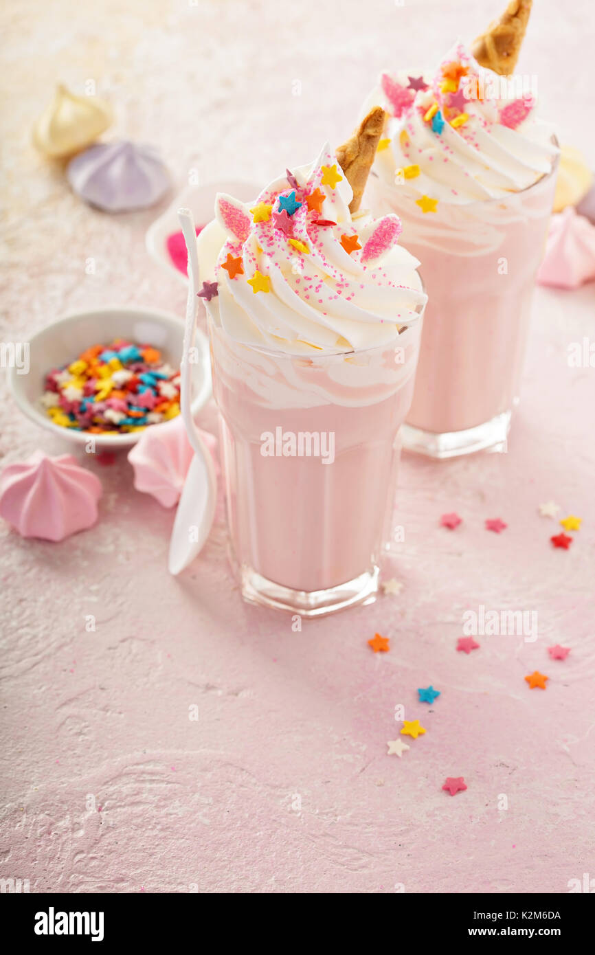 Pink unicorn milkshakes with whipped cream, sugar and sprinkles Stock Photo