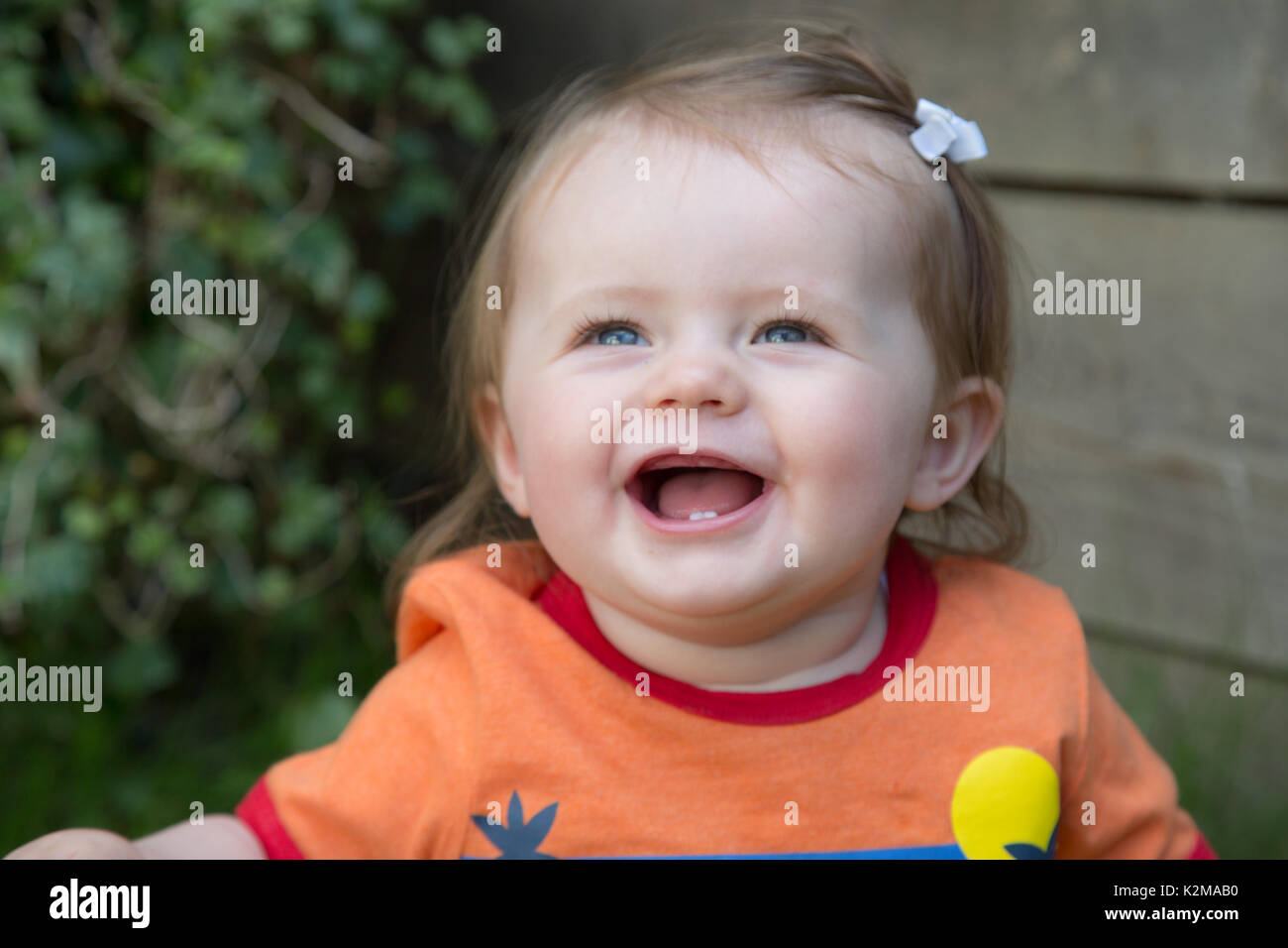 Happy 10 month old baby girl clapping Stock Photo Alamy