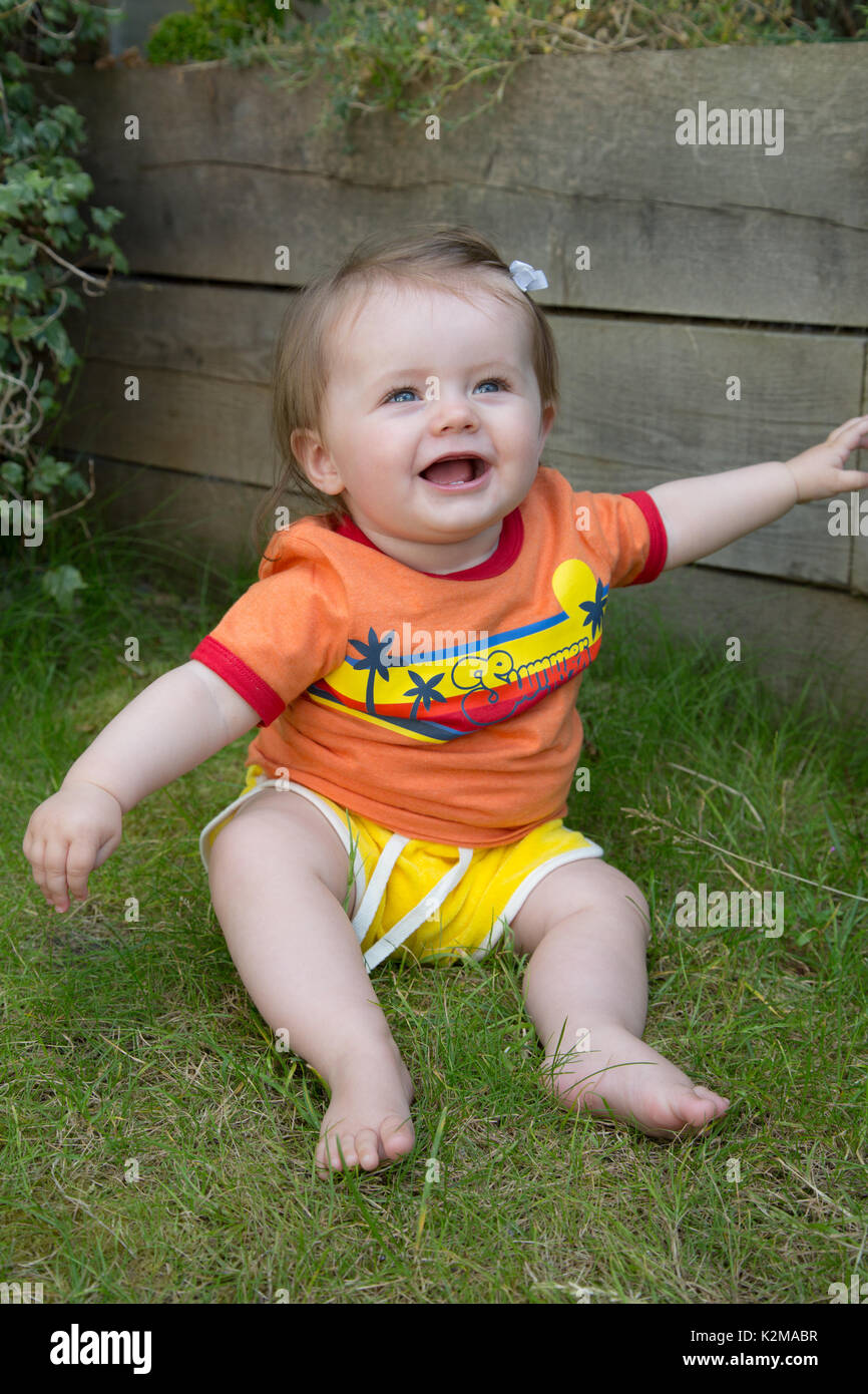 Happy 10 month old baby girl clapping Stock Photo Alamy
