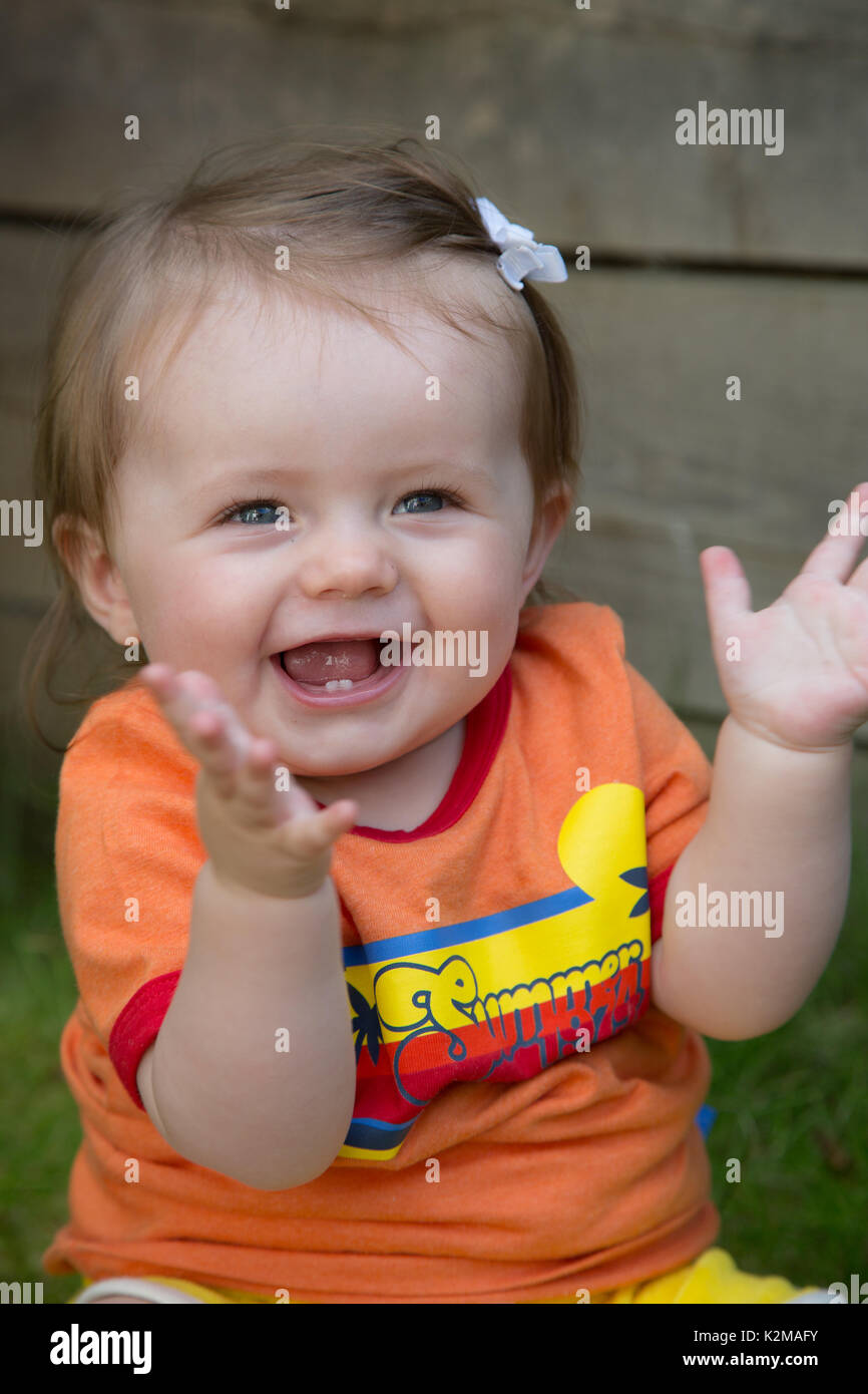 Happy 10 month old baby girl clapping Stock Photo Alamy