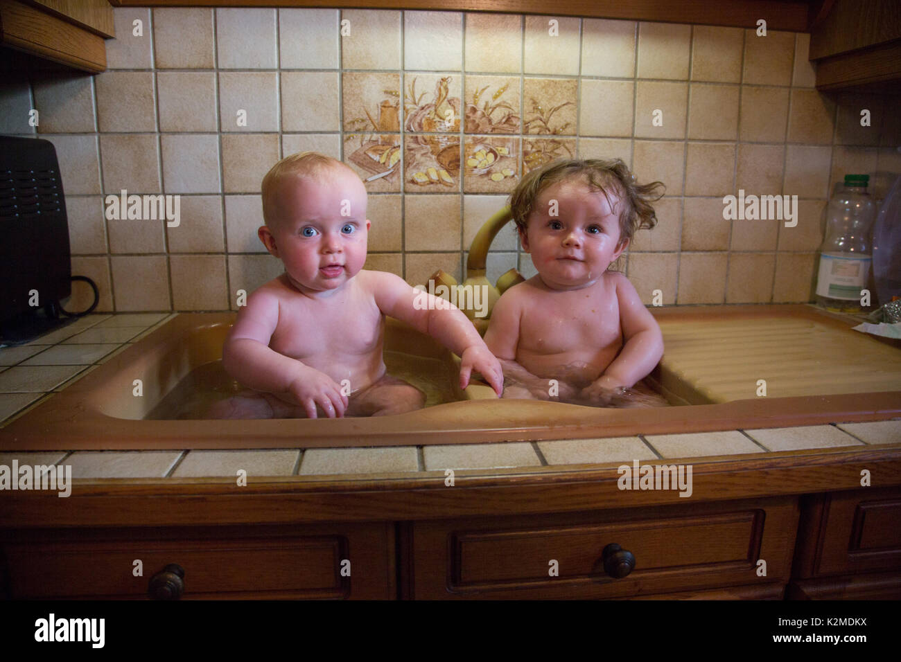 Infant bath in the kitchen sink hires stock photography and images Alamy