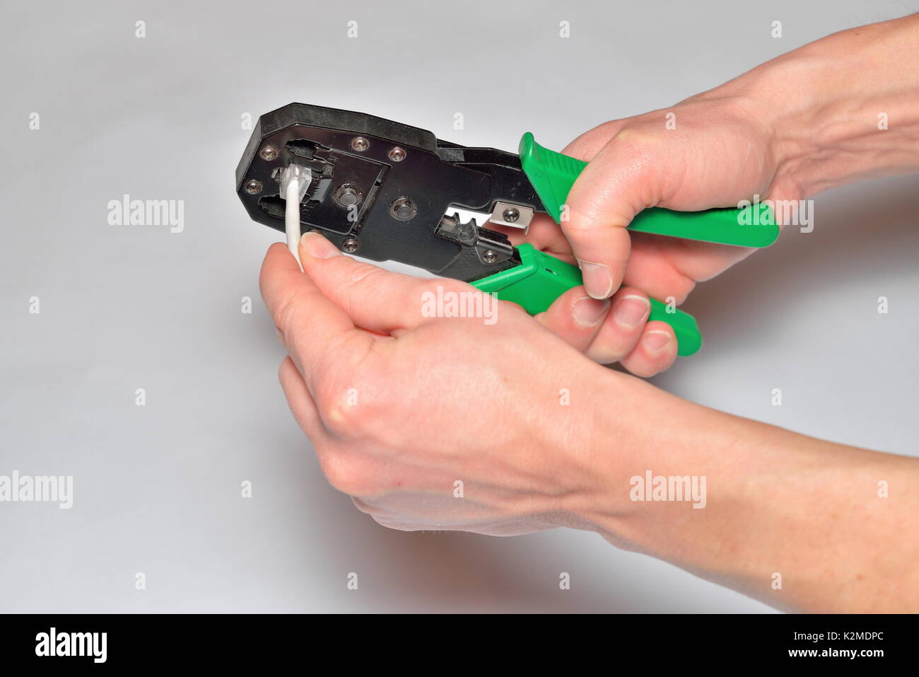 Hands of the installer, computer network, fix the connector on t Stock Photo