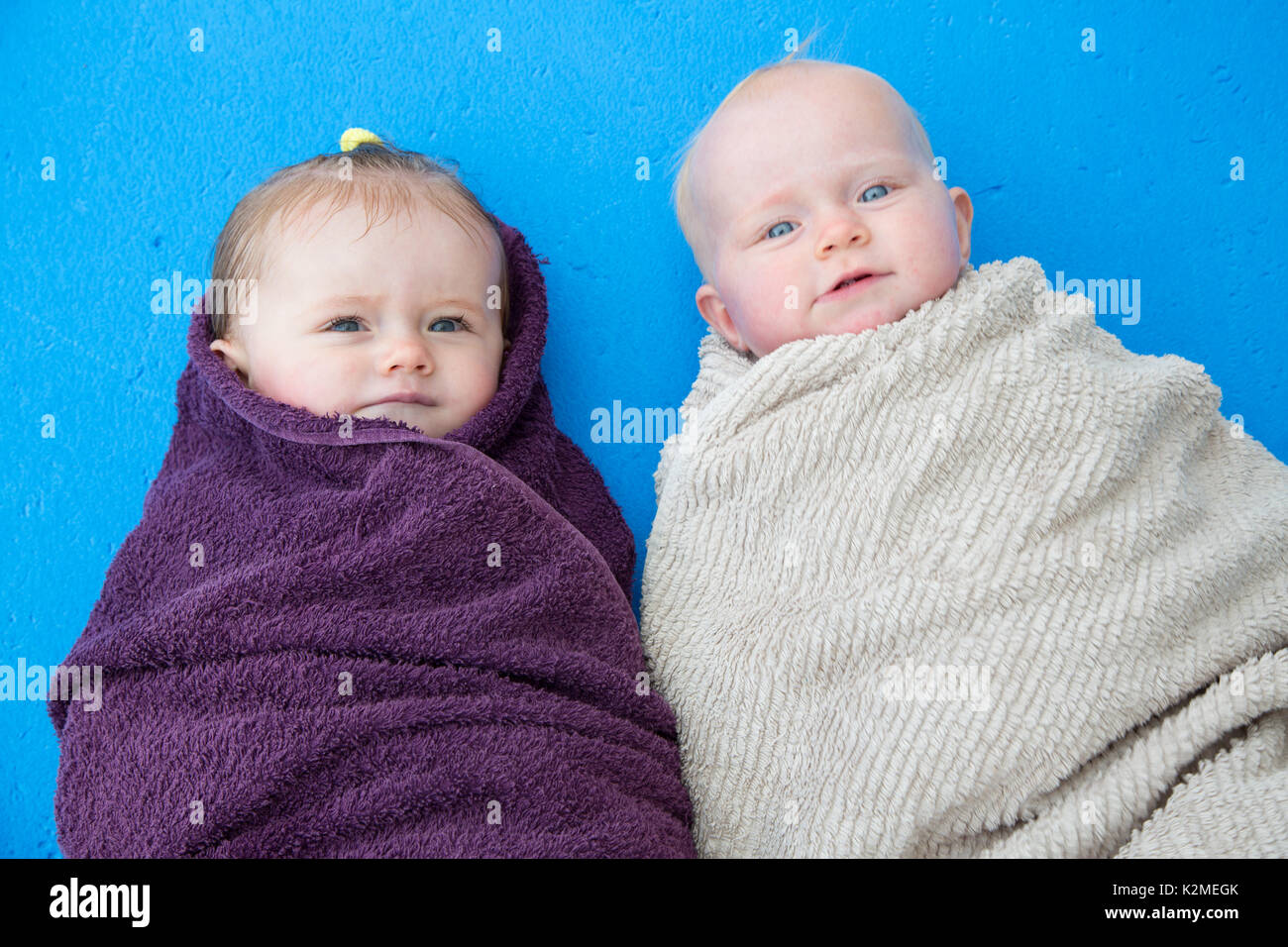 10 month old babies wrapped up in towels after swimming Stock Photo Alamy