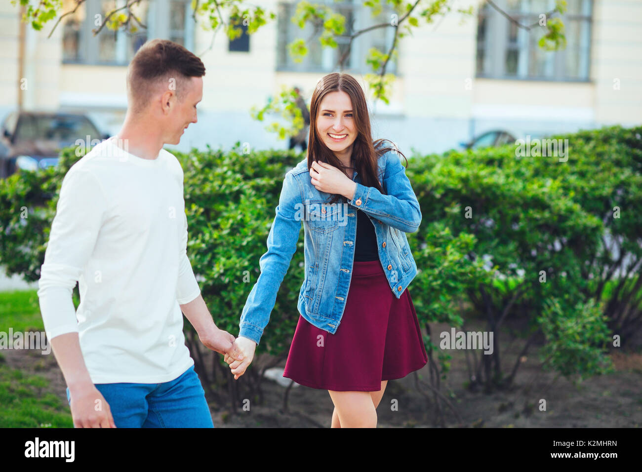 Couple of tourists taking a walk in a city street sidewalk in a sunny day Stock Photo