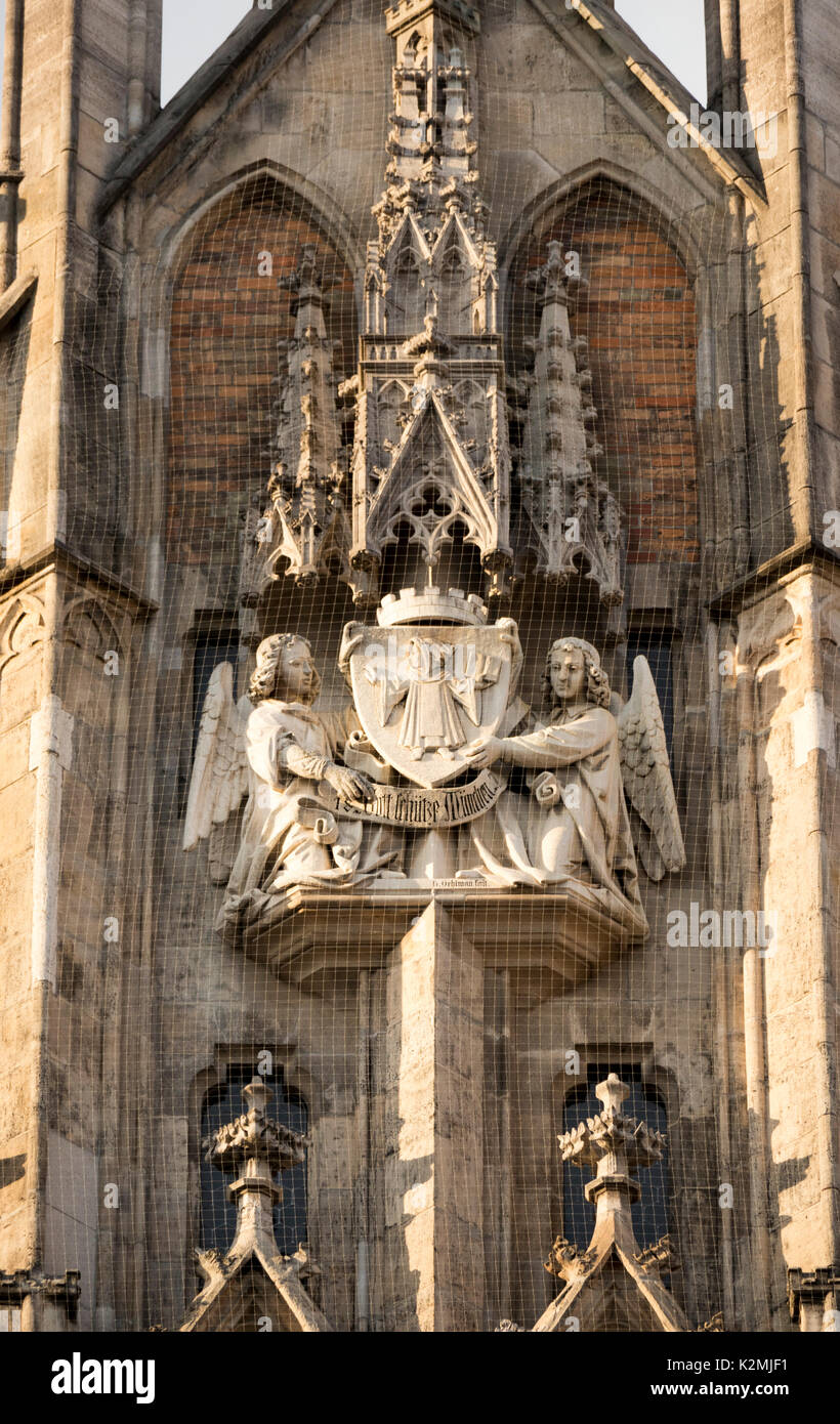sculpture from the New Town Hall (Neues Rathaus) of angels holding the Munich, Germany coat of arms, the Münchner Kindl or Munich child Stock Photo