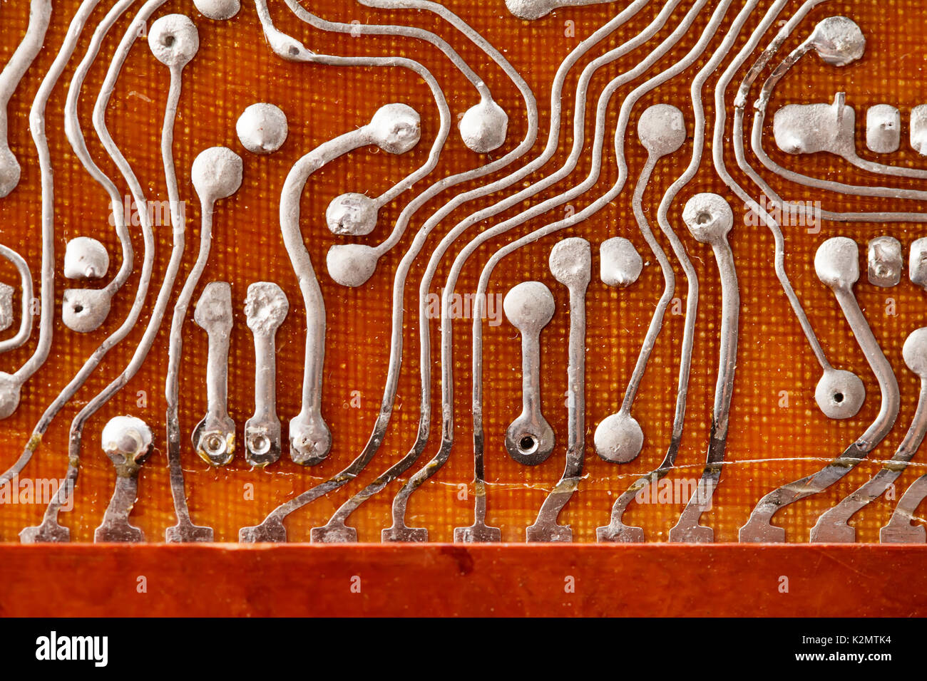 Circuit board background with soldering macro view. Retro technologies concept. Shallow depth of field photo Stock Photo