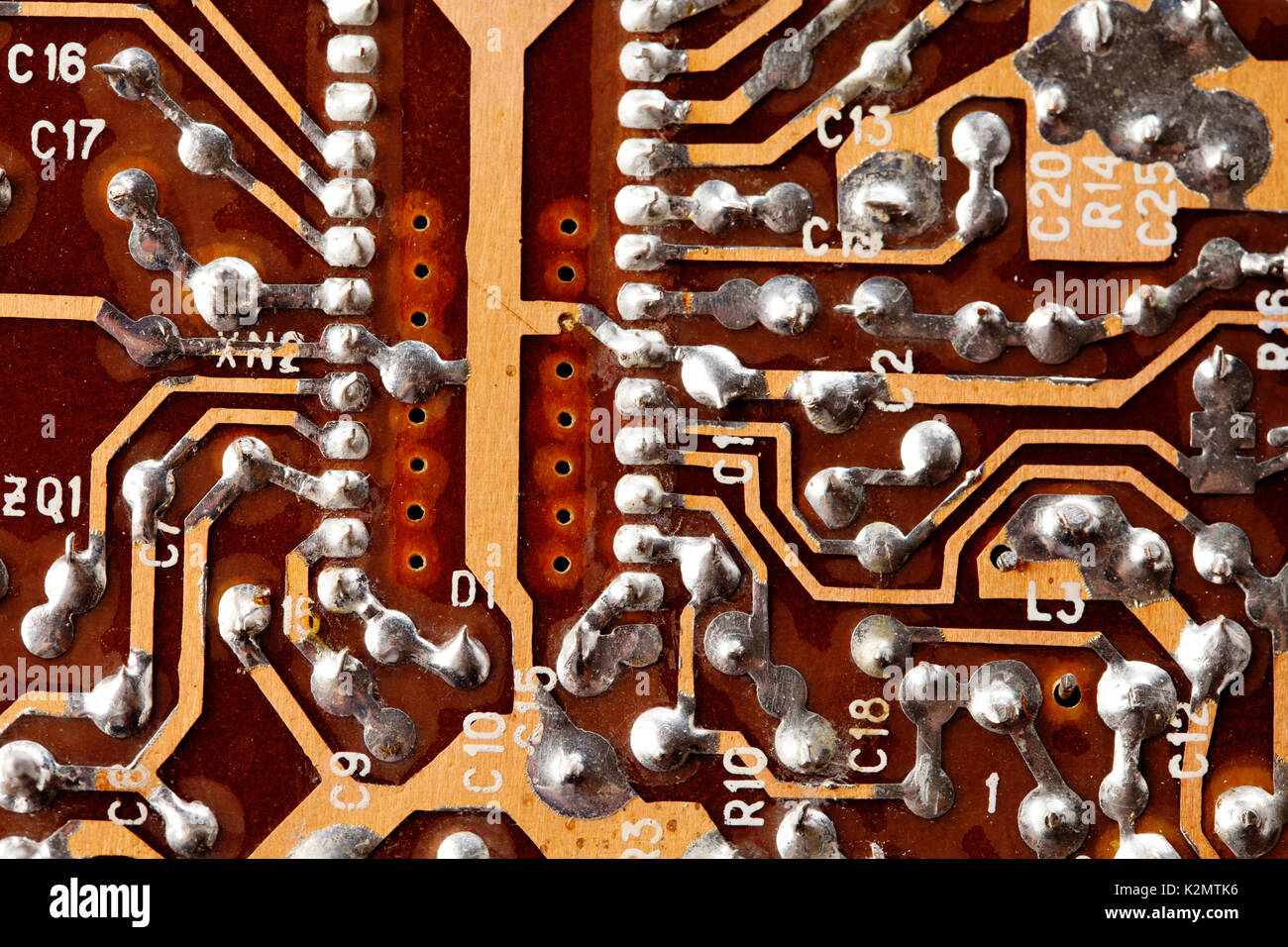 Circuit board chip macro view. Vintage electronic component with soldering traces. Old style design hardware Stock Photo