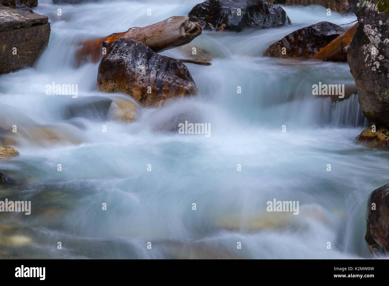 Nature detail: water stream which goes among big stones Stock Photo - Alamy