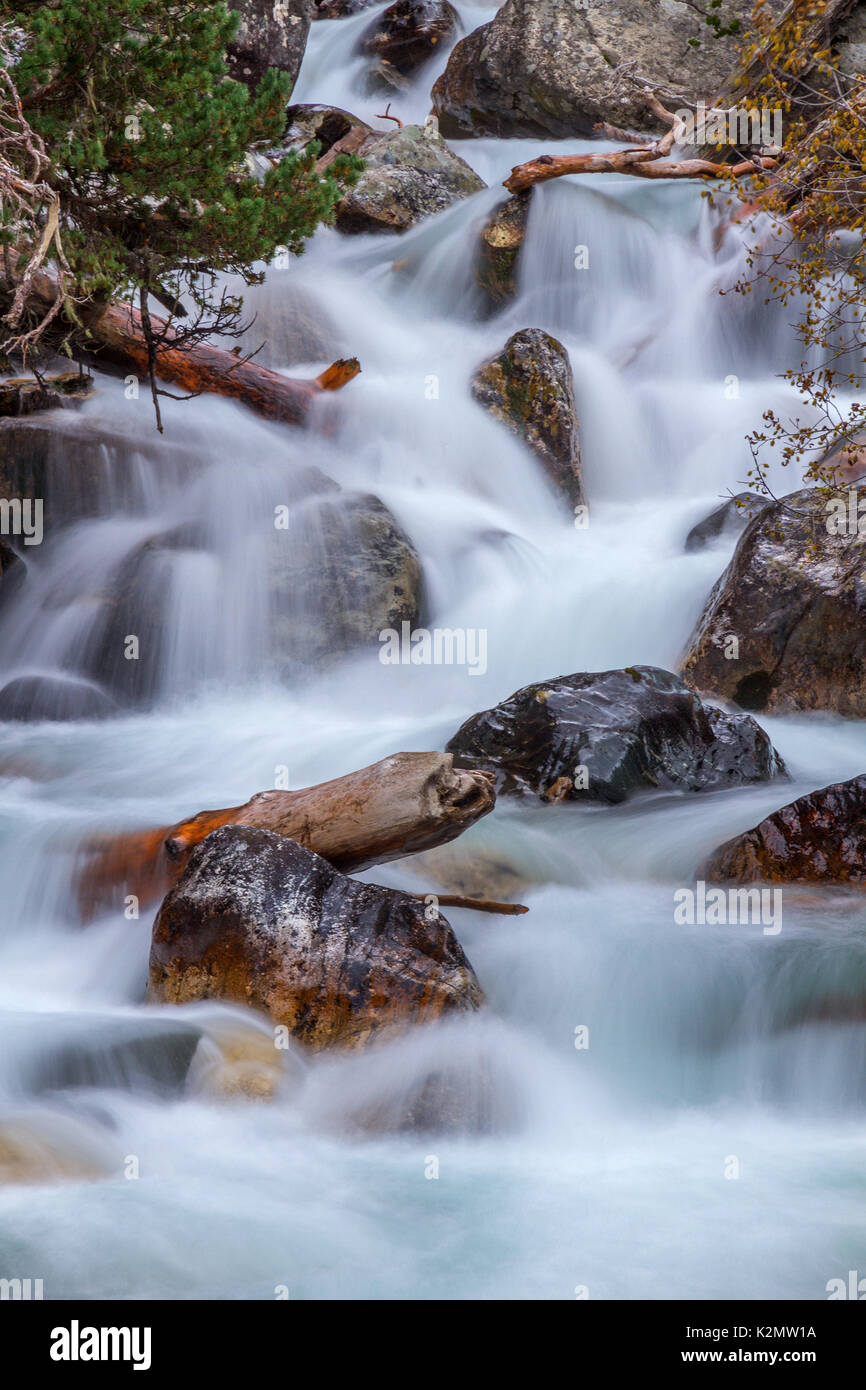 Nature detail: water stream which goes among big stones Stock Photo - Alamy