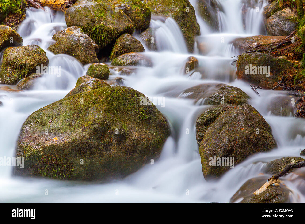 Nature detail: water stream which goes among big stones Stock Photo - Alamy