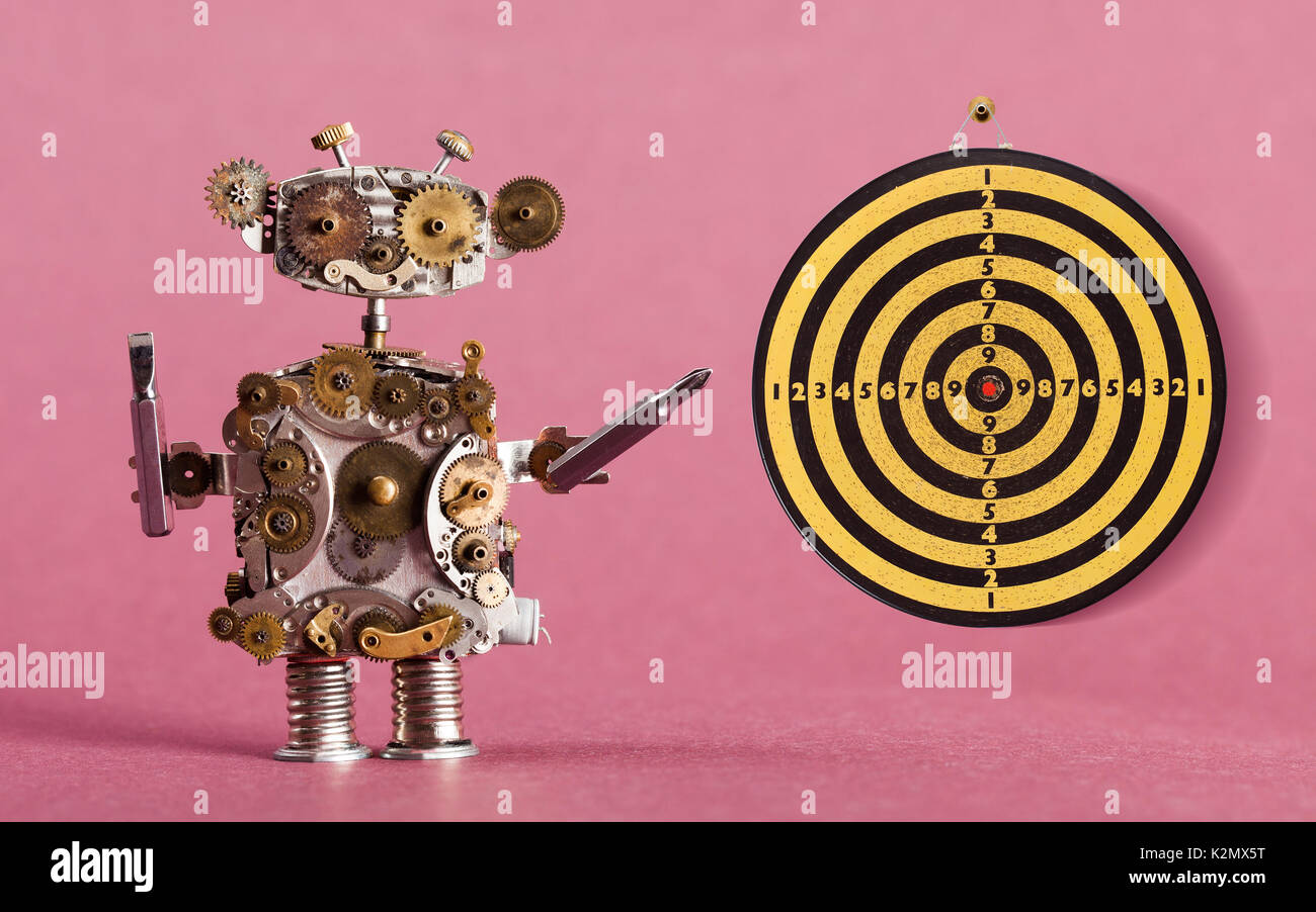 Steampunk robot handyman with screw drivers and dart board, vintage yellow  black shooting target red center. Pink background Stock Photo - Alamy