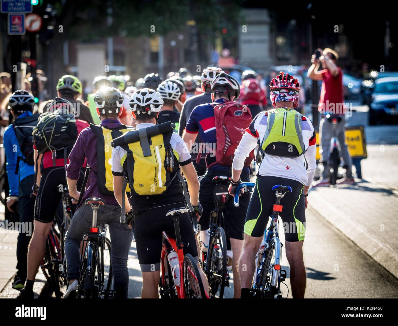 Cycling to work London. London Commuter cyclists on a cycle lane on Westminster Bridge. Bike Commuters queue at traffic lights. Stock Photo