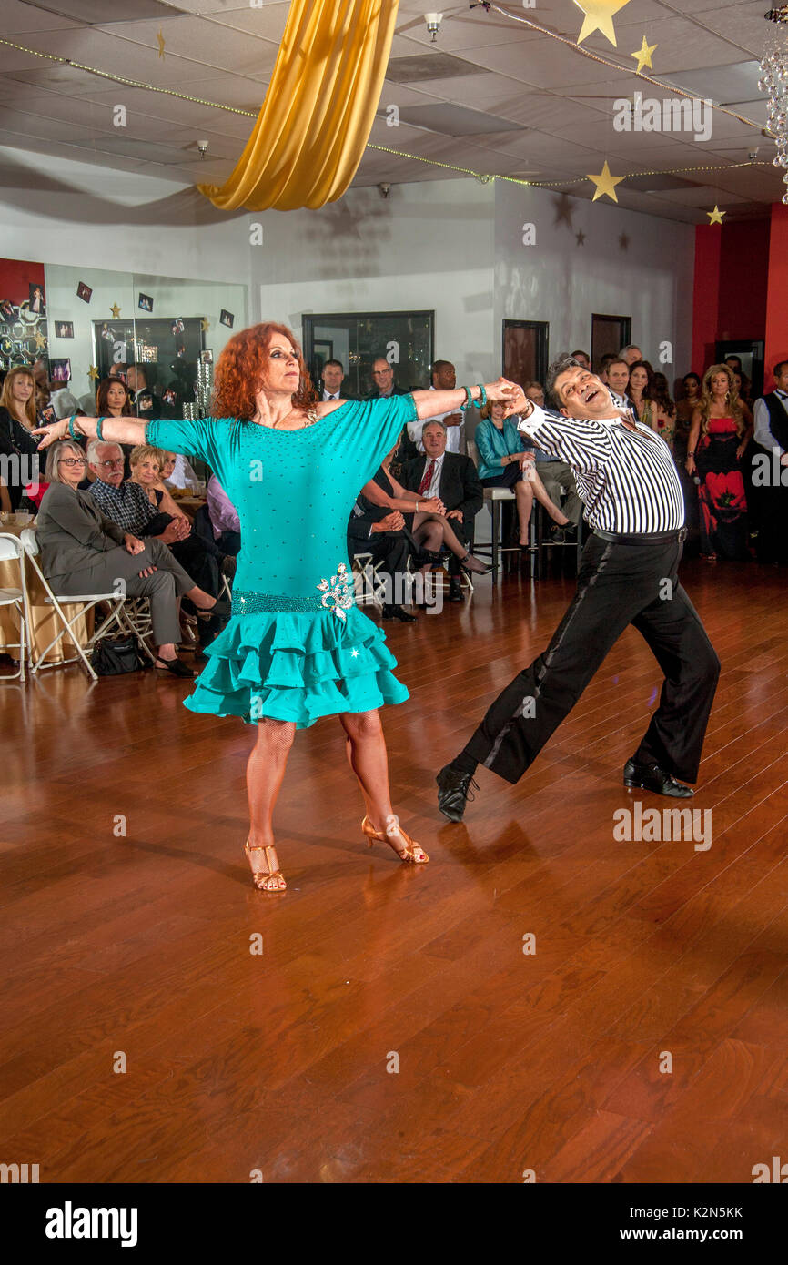 Professional ballroom dancers perform at a dance school anniversary