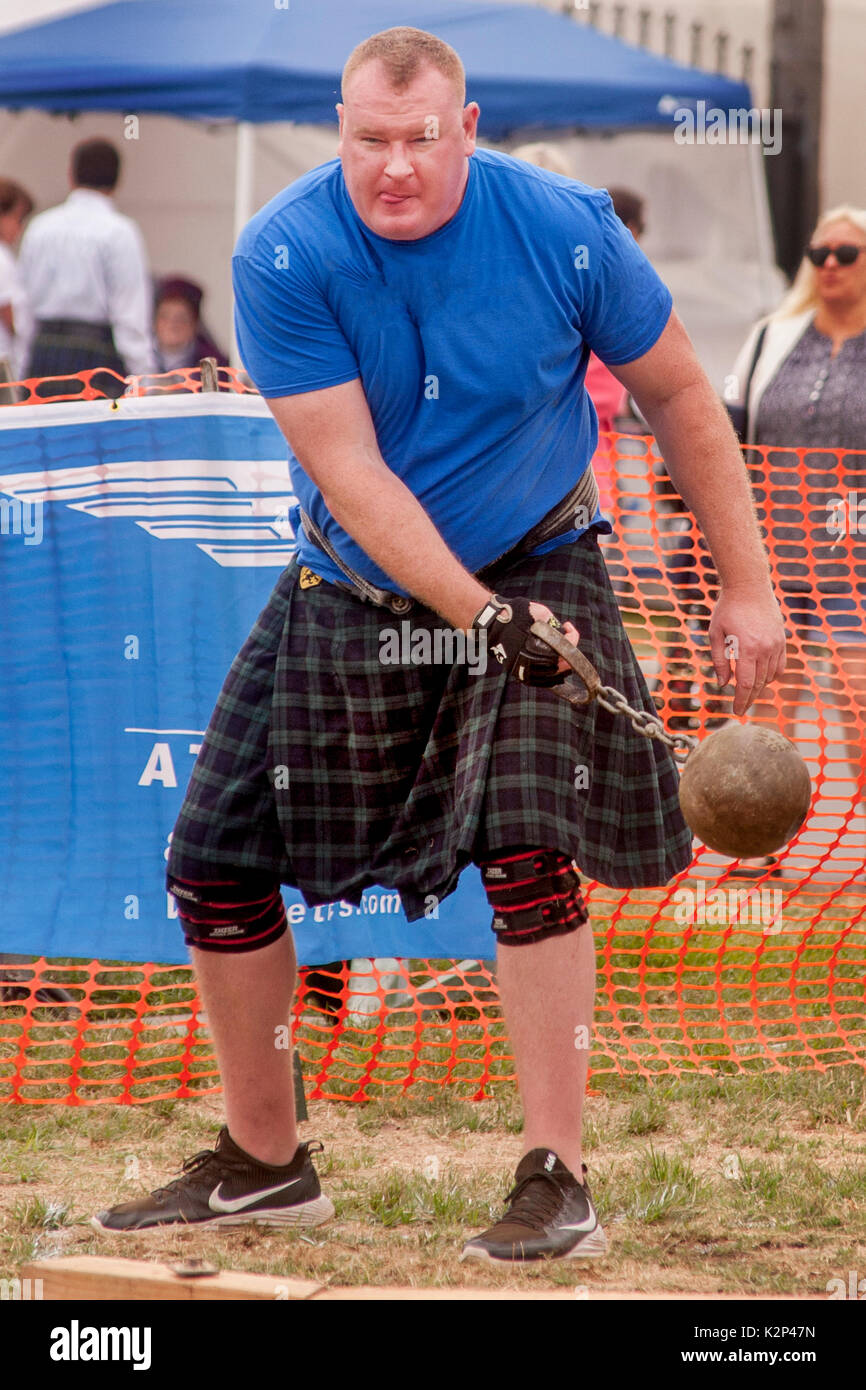 A hefty kilted contestant in the hammer throwing event swings his 16-pound ball at an ethnic Scottish festival in Costa Mesa, CA. Stock Photo
