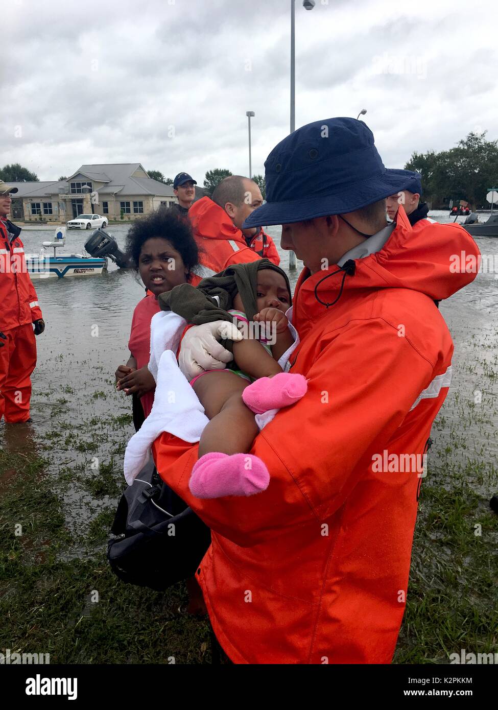 Port Arthur, United States. 30th Aug, 2017. U.S. Coast Guard Petty Officer 3rd Class Ryan Hicks rescues a child from flooding in the aftermath of Hurricane Harvey August 30, 2017 in Port Arthur, Texas. Credit: Planetpix/Alamy Live News Stock Photo