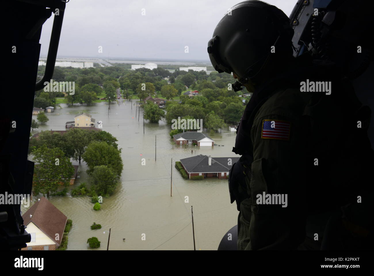 Beaumont, United States. 30th Aug, 2017. U.S. Coast Guard aircrew personnel look out at flood neighborhoods as they respond to an emergency evacuation by helicopter in the aftermath of Hurricane Harvey August 30, 2017 in Beaumont, Texas. Credit: Planetpix/Alamy Live News Stock Photo