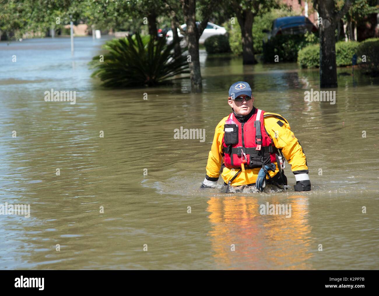 Sugar Land, United States. 30th Aug, 2017. Texas National Guard Rescue Specialist Samuel Hendricks, wades through a residential area searching for stranded residents in the aftermath of Hurricane Harvey August 30, 2017 in Sugar Land, Texas. Credit: Planetpix/Alamy Live News Stock Photo