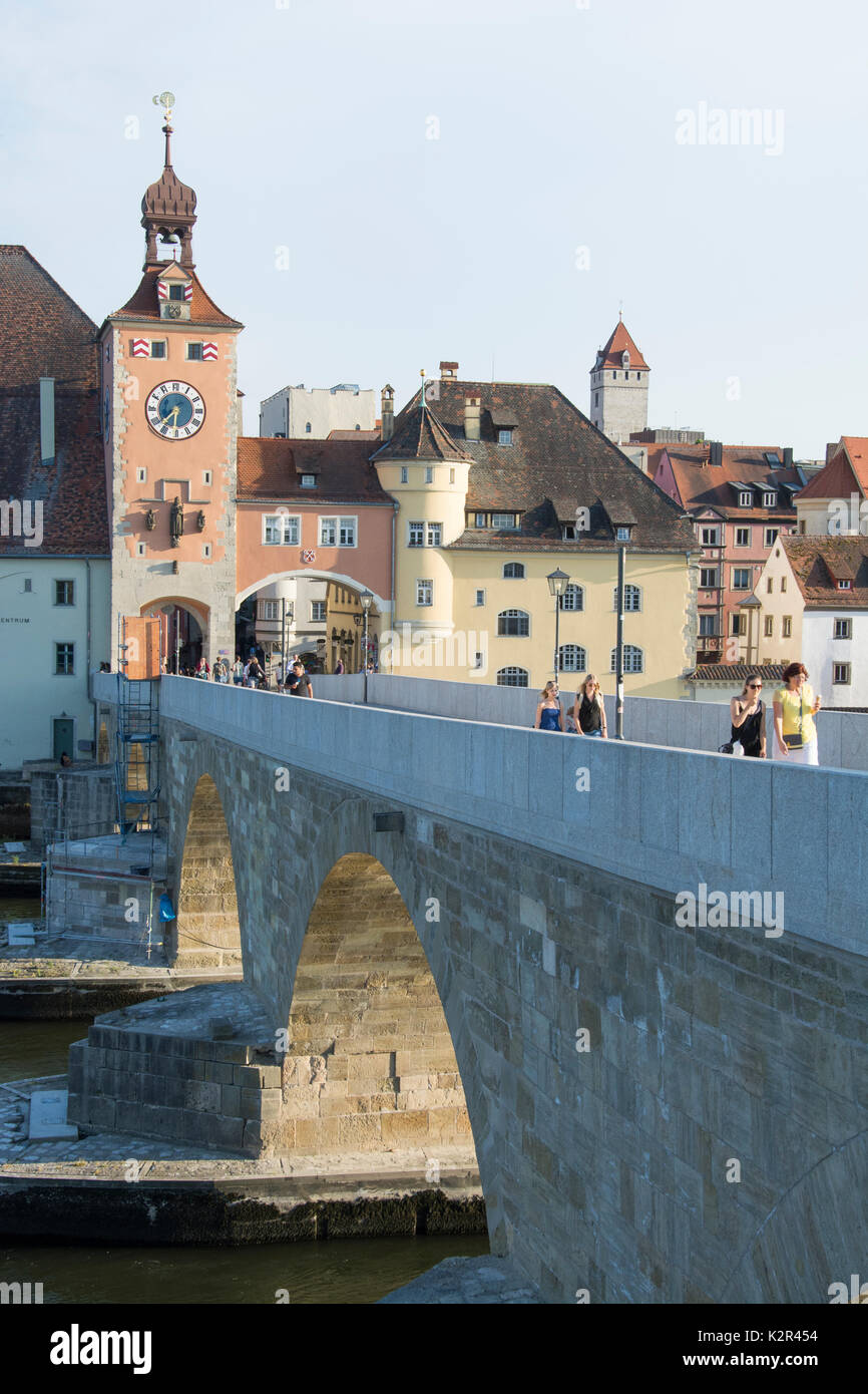Crossing the Danube (Donau) on a restored section of the Stone Bridge or Steinerne Bruecke at Regensburg, Bavaria, Germany Stock Photo