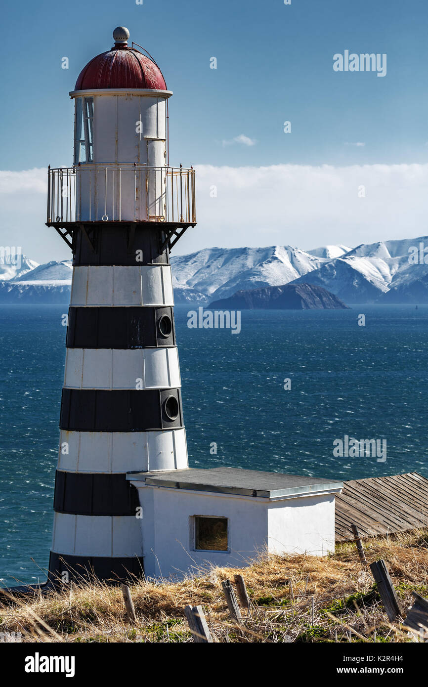 Petropavlovsky Lighthouse (founded in 1850) is located on Mayachny Cape on Kamchatka Peninsula on shore of picturesque Avacha Gulf in Pacific Ocean Stock Photo