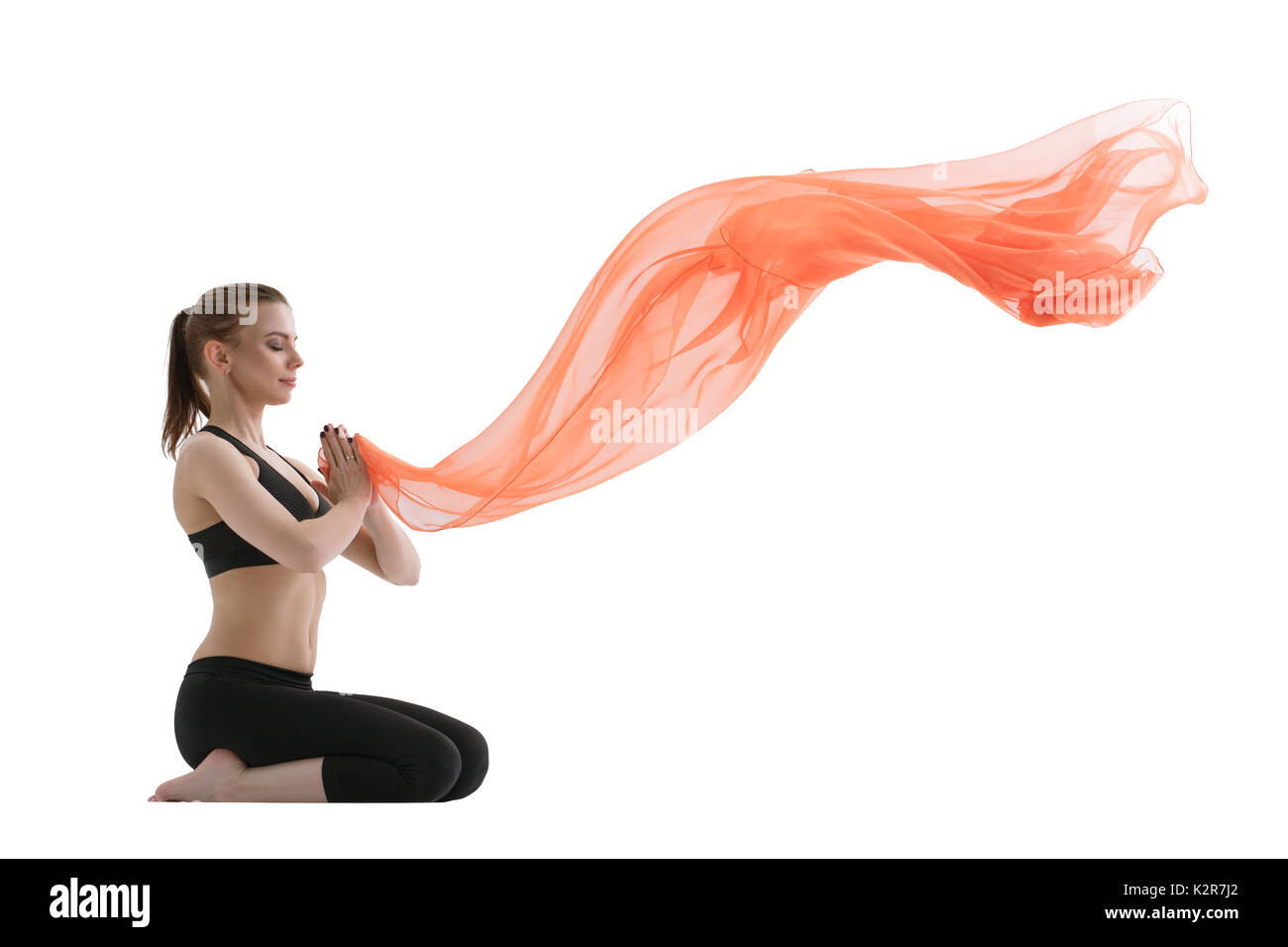 Yuong girl doing yoga posing with red cloth Stock Photo