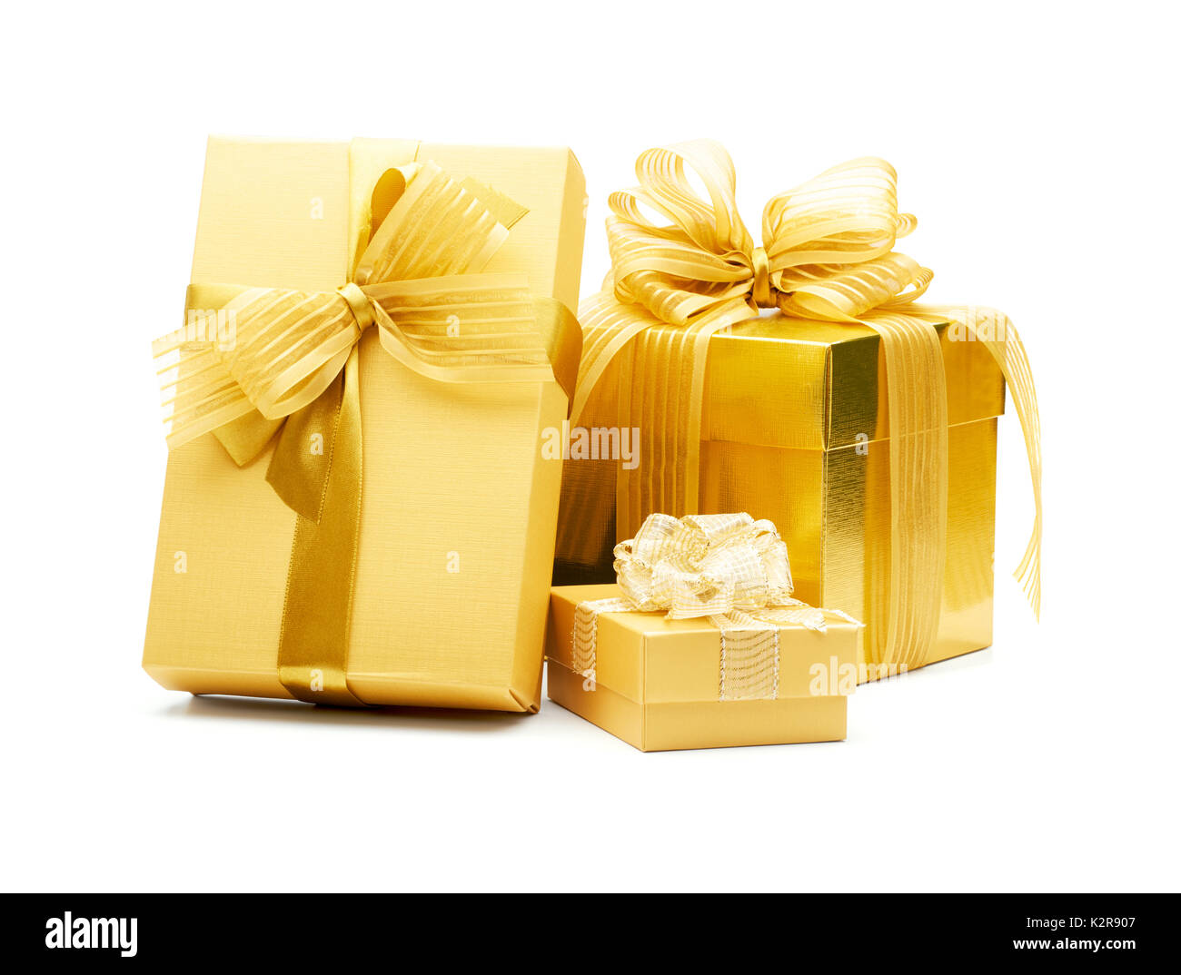 Golden gift boxes with ribbon on white background Stock Photo - Alamy