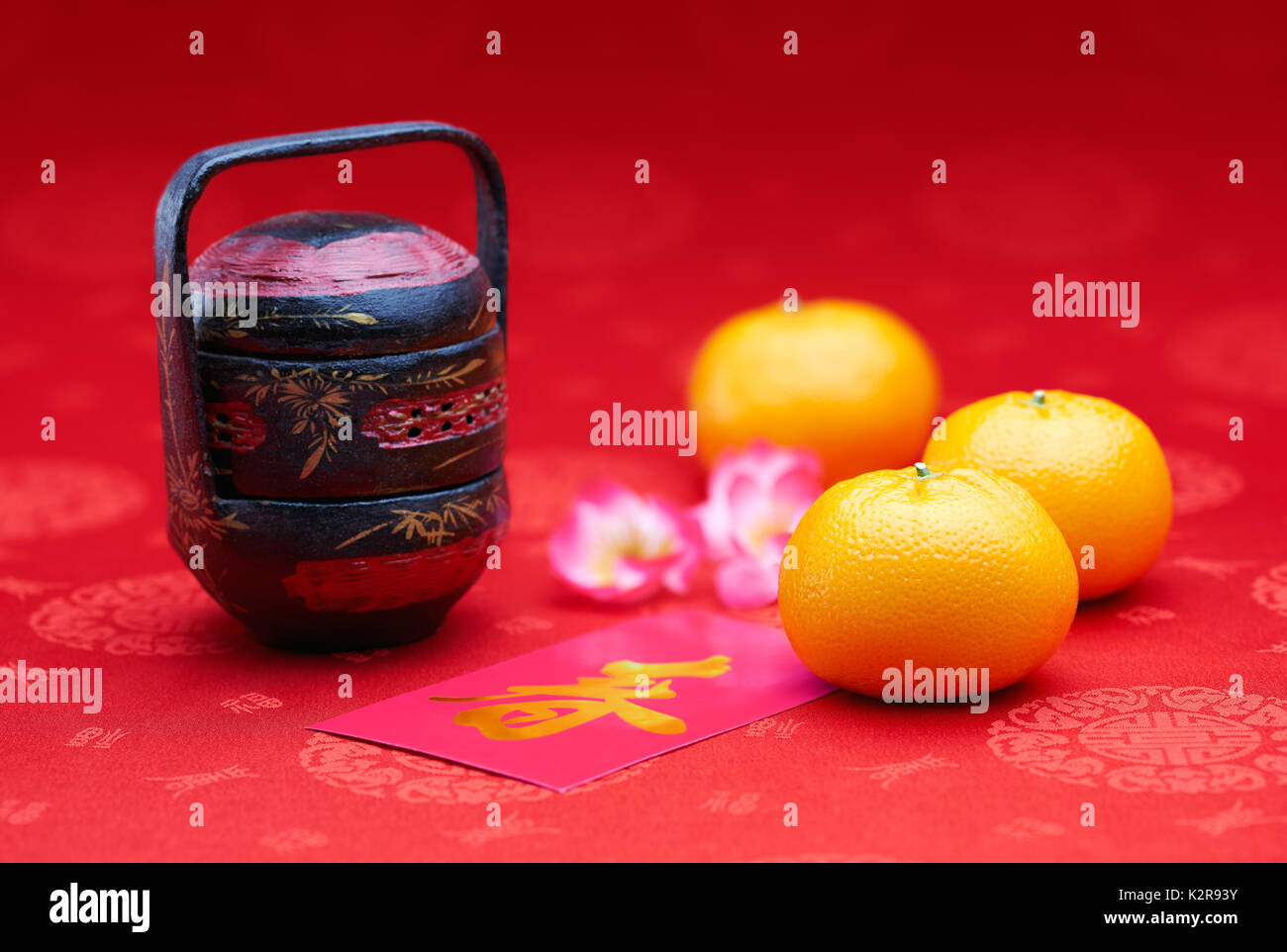 Chinese New Year - Mandarin orange and pink packet (Foreign text means spring season) Stock Photo