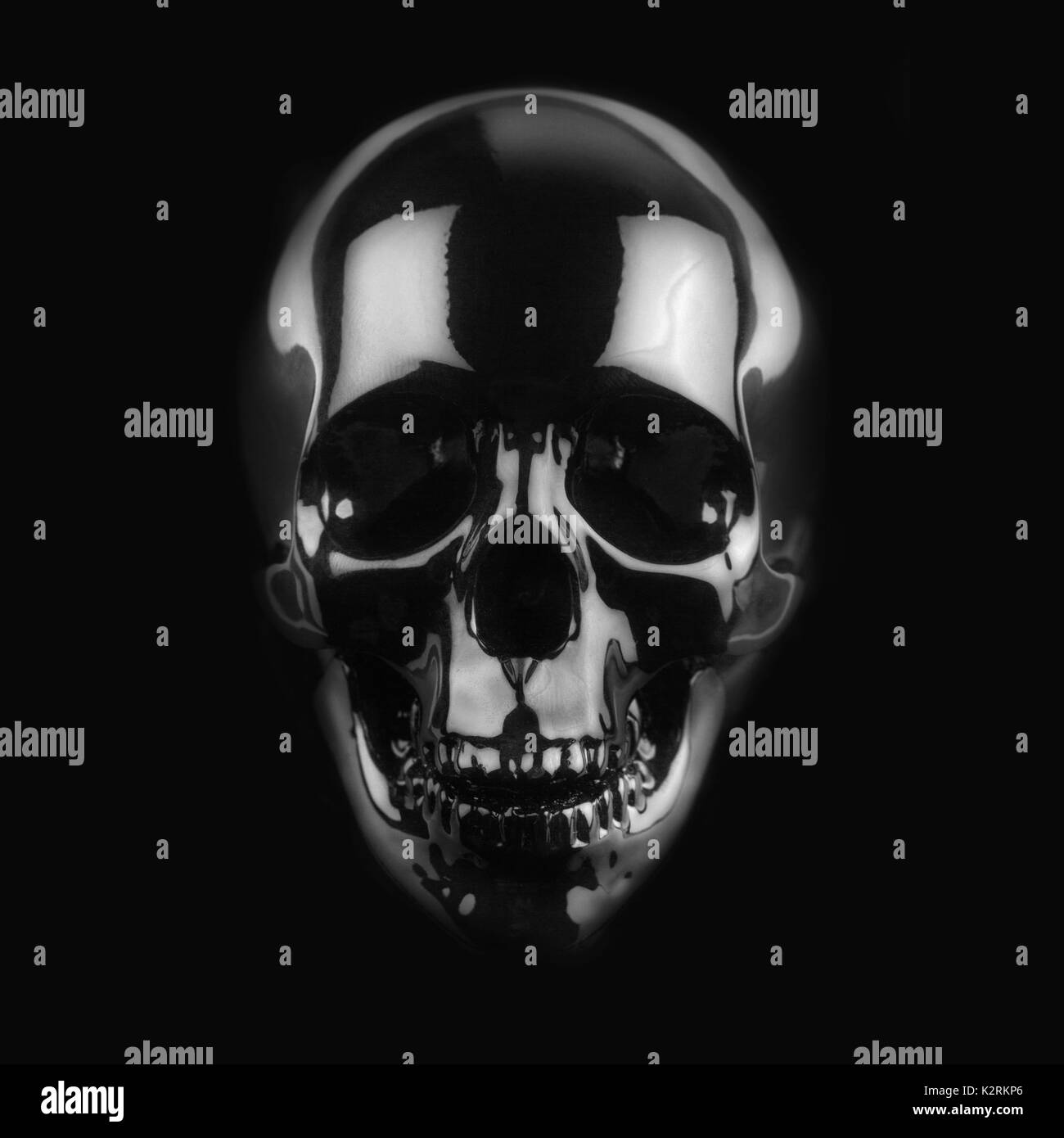 front view of polished shinny wooden skull on dark background Stock Photo