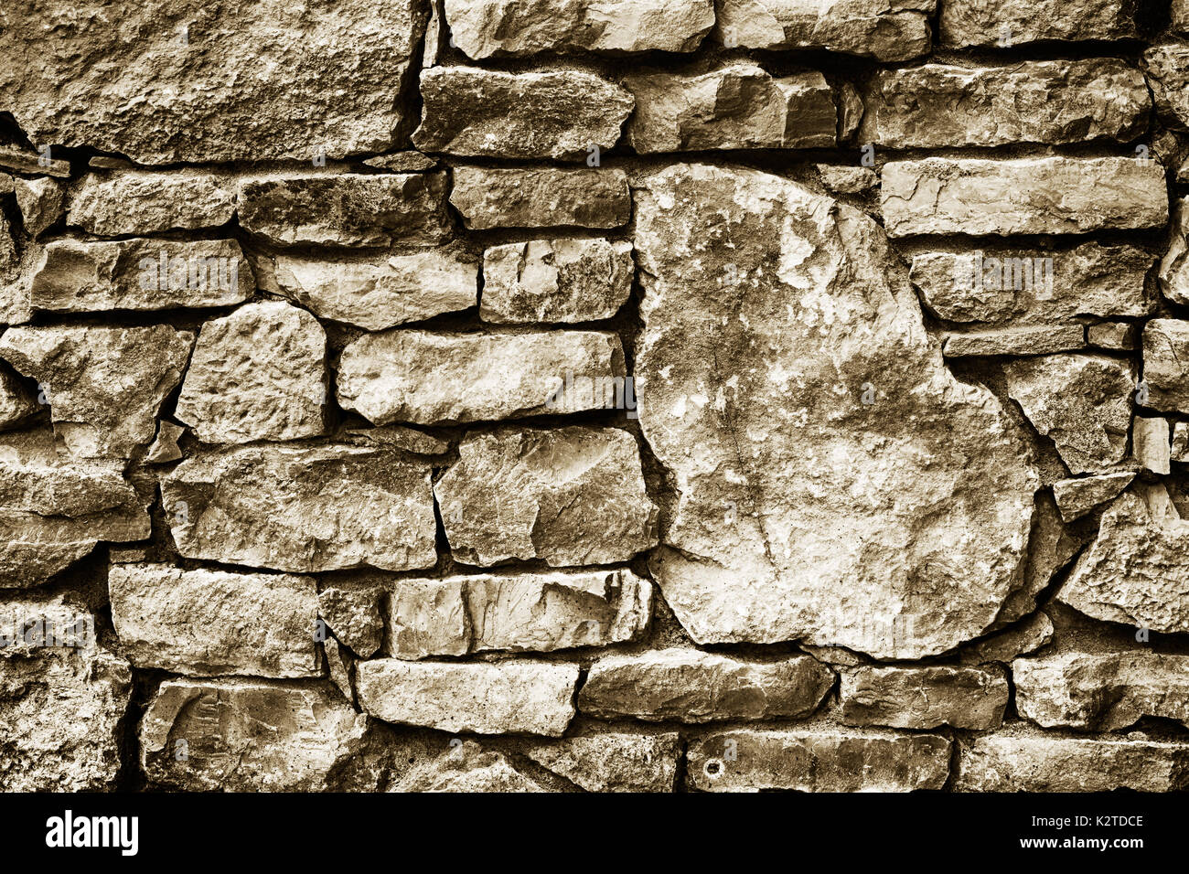 black and white texture background of a wall lined with natural stone ...