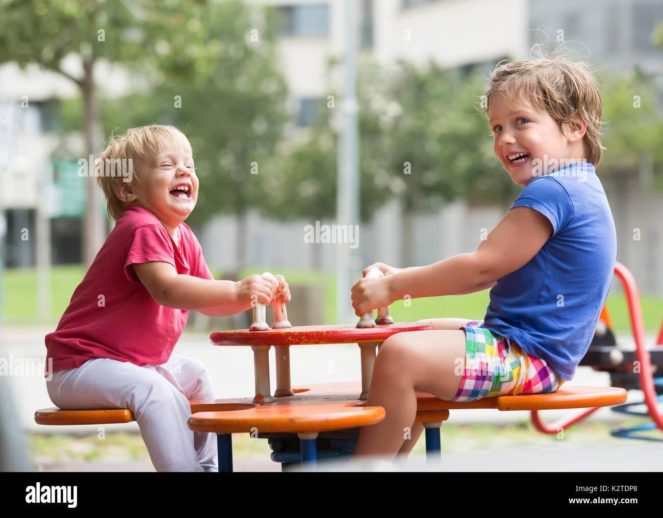 Cheerful smiling little siblings having fun at city playground Stock ...