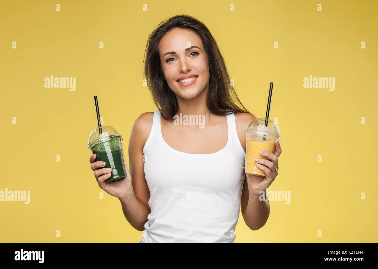 https://c8.alamy.com/comp/K2TEN4/young-attractive-brunette-woman-holding-takeaway-cups-of-smoothie-K2TEN4.jpg