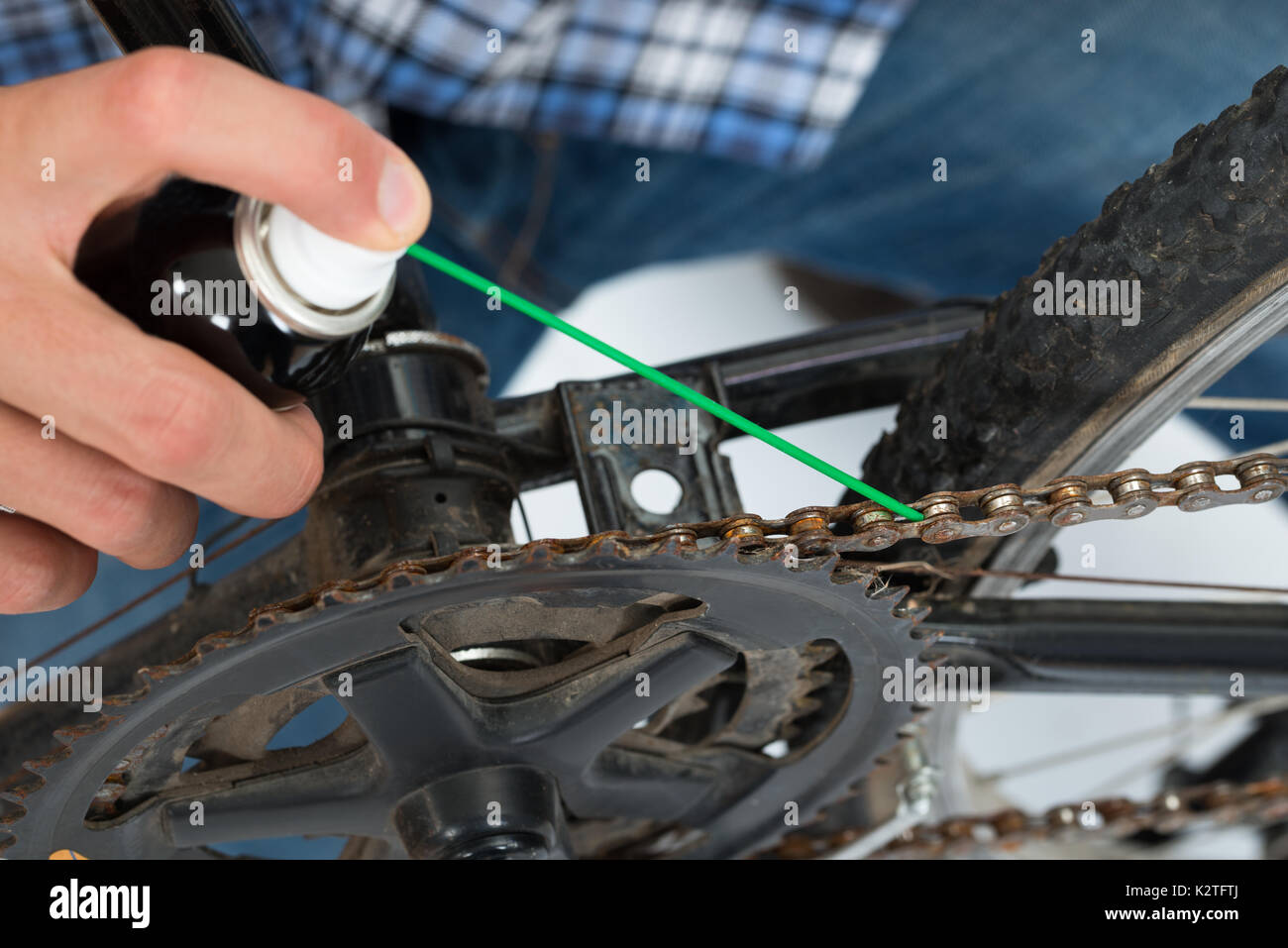 Close-up Of Person Hands Lubricating Bike Chain Stock Photo