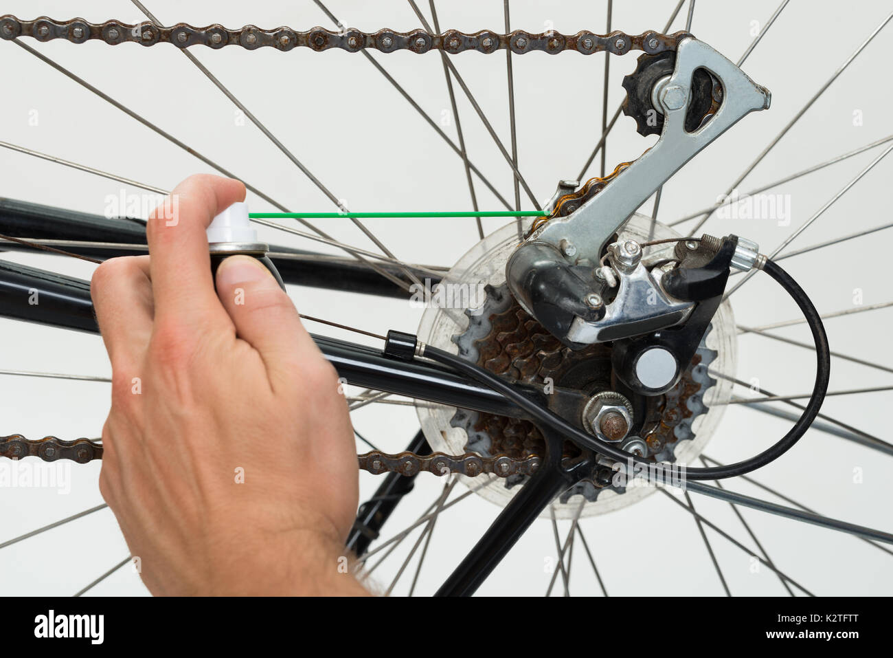 Close-up Of Person Hands Lubricating Bike Chain Stock Photo