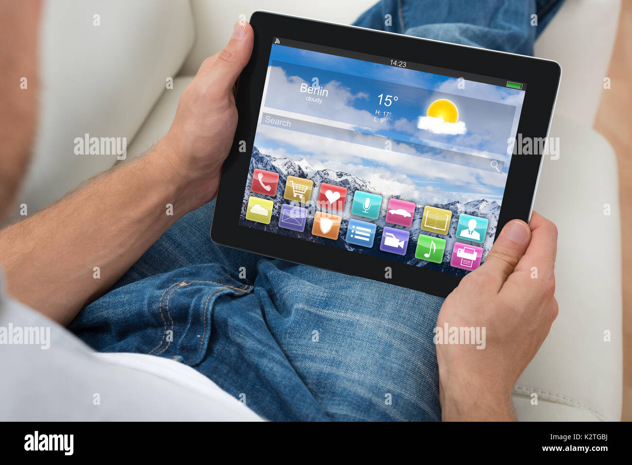 Close-up Of Person Holding Digital Tablet Showing Apps On Display Stock Photo